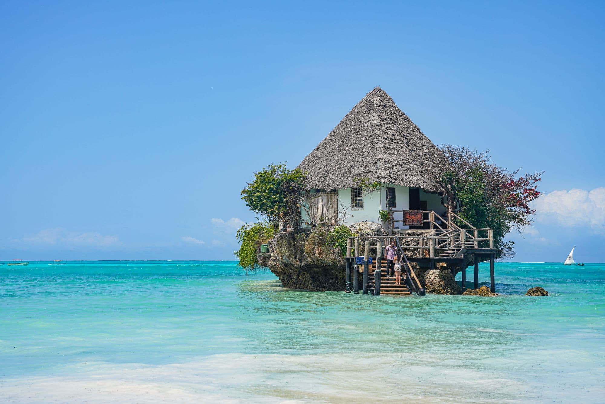 The Rock restaurant perched on a coral outcrop in the turquoise waters off Zanzibar