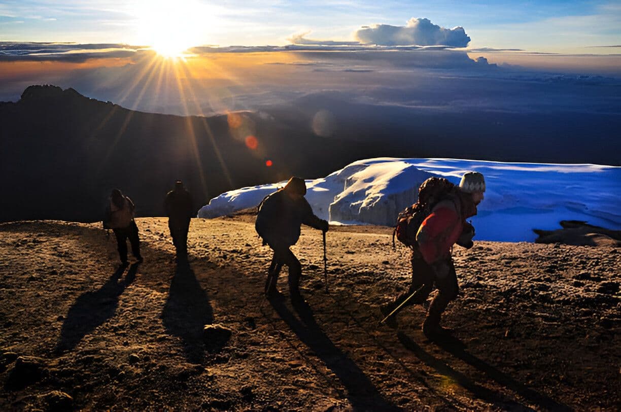 Climbers near the summit at sunrise